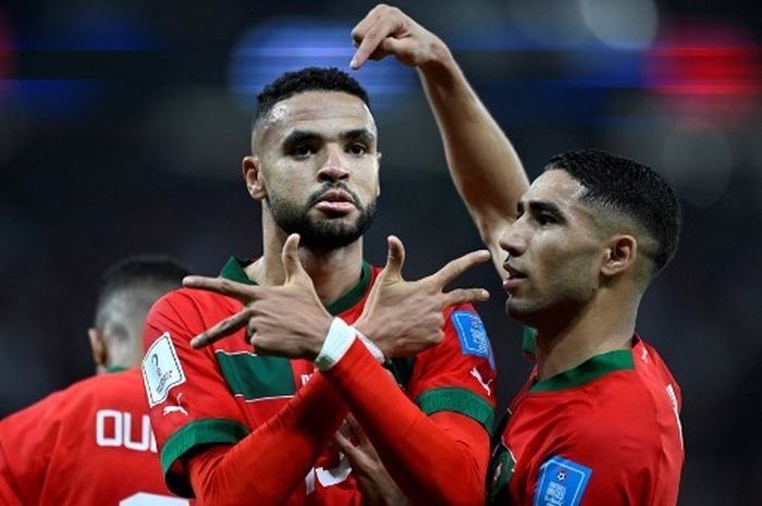 Morocco's forward #19 Youssef En-Nesyri (L) celebrates scoring the opening goal with Morocco's defender #02 Achraf Hakimi during the Qatar 2022 World Cup quarter-final football match between Morocco and Portugal at the Al-Thumama Stadium in Doha on December 10, 2022. (Photo by PATRICIA DE MELO MORE